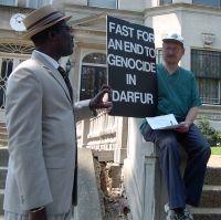 A well-dressed Sudanese man chats with Scott Schaeffer-Duffy